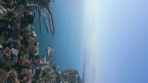 The camera flies from the side of the old city of Antalya to the sea bay Stock Footage 229614230