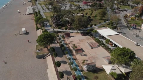 The camera flies up to a skate park located on the seashore, where riders ride Stock Footage 220421192