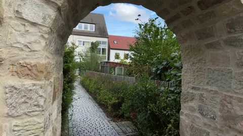Camera flies in through an arched passage in a medieval wall. Stock Footage 221356630