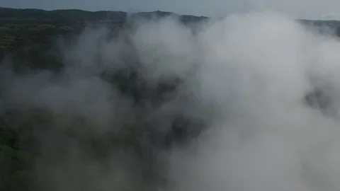Camera flies through a cloud over the mountains Stock Footage 83589394