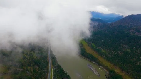 Camera flies through the clouds, aerial view of the mountain river Stock Footage 92604832