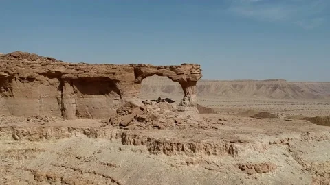 The camera flies towards The Natural Arch of Riyadh Stock Footage 153038438