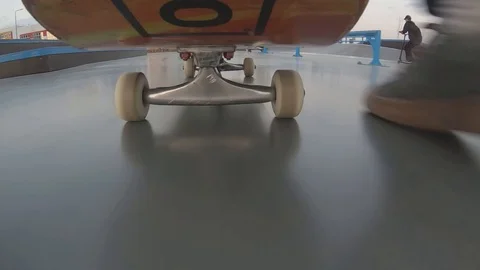 The camera flies under a skateboard while riding with a stunt Stock Footage 130051100