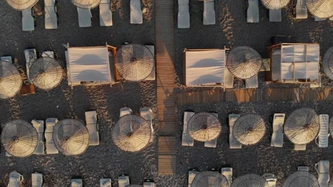 The camera flies vertically up over the sun loungers on the beach. Top-down view Stock Footage 221583077