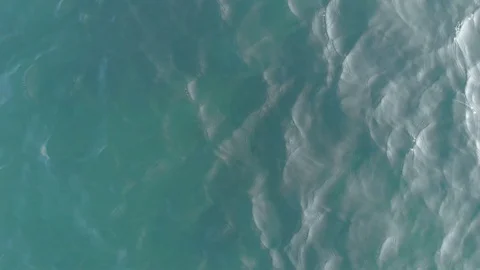 The camera flies up vertically upwards. Top-down view of the sea waves. Sea Stock Footage 118935683