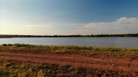 The camera flies very low over the bank towards the lake. Stock Footage 106926360