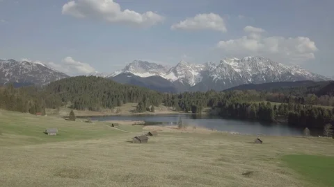 Camera flight above green slope with the mountain on the background Stock Footage 89788945