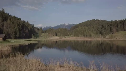Camera flight above the lake full of cone surrounded by hills aerial footage Stock Footage 89763642