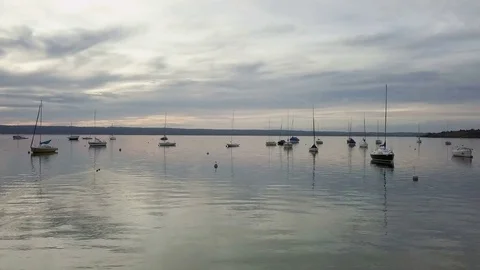 Camera flight above the lake with a lot of boats sunset time - Aerial Stock Footage 83770520