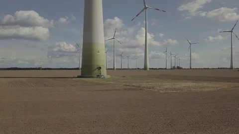 Camera Flight up along the windmill turbine. Windmill field on background Aerial Stock Footage 83800590
