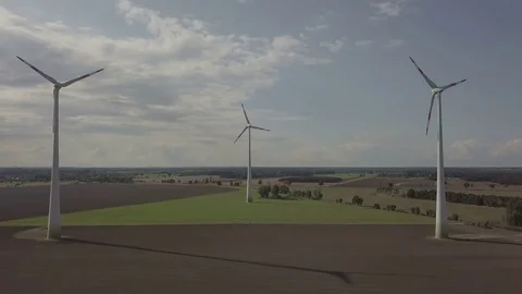 Camera flight between two working windmills. Energy Production - Aerial Stock Footage 83820175