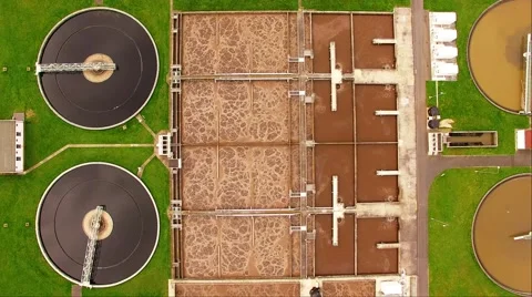 Camera flight over biogas plant from sewage treatment in green fields Stock Footage 62771949