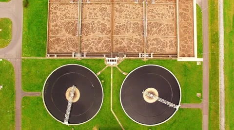 Camera flight over biogas plant from sewage treatment in green fields Video stock 62772243