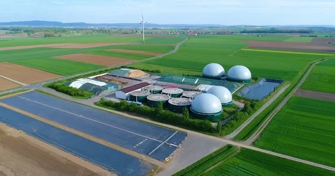Camera flight over biogas plant from pig farm. Renewable energy from biomass Stock Footage