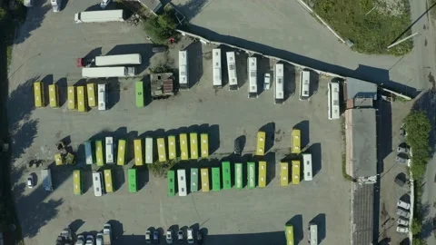 Camera flight over a parking lot with cars, trucks and buses. Automotive Stock Footage 136538278