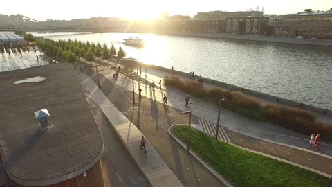 Camera flight at sunset over the Moscow river and pleasure boats Stock Footage 129873171