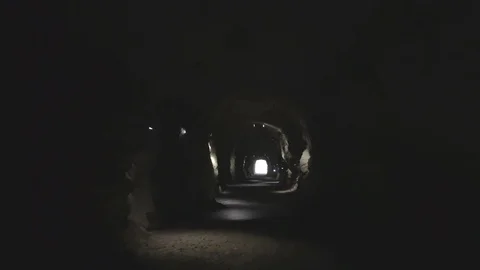 Camera flight through the dark tunnel with the light in the end of the tunnel Stock Footage