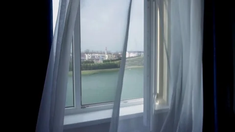 Camera flight through an open window with a view of the lake outside the window. Stock Footage 90400130