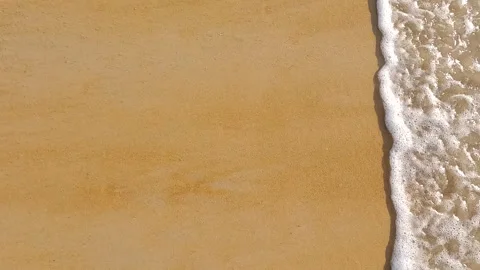 Camera fly above golden sand and crystal clear sea Stock Footage 327476981