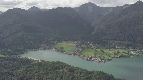 Camera fly above the lake and the small village next to it Aerial Stock Footage 83763675