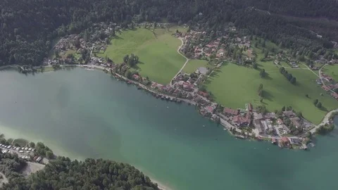 Camera fly above the lake and the small village from far away- Top down Aerial Stock Footage 83765294