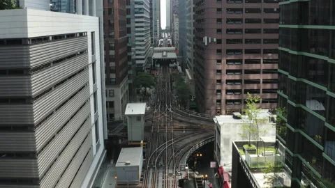 Camera fly above street between modern high rise buildings over a railroad Stock Footage 195410941