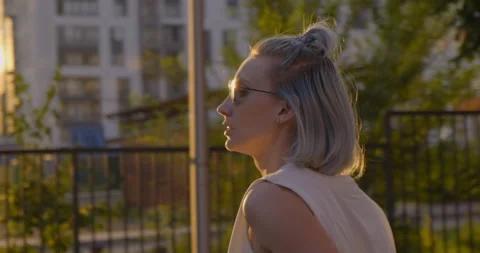Camera Fly around Girl. Close-up. Summer. Park. Sunset. Rays of Sun. Soft Light Stock Footage 136737559
