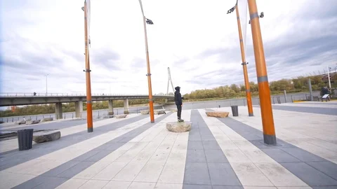 Camera fly around skater staying on stone at promenade Stock Footage 120445466
