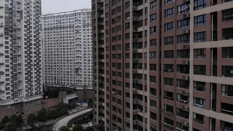 Camera fly down near with tall residential tower at Chinese city Stock Footage 101124522