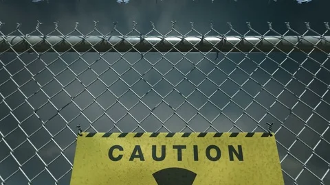 Camera fly over the barbed wire fence. Radioactive warning sign. Stock Footage 79261329