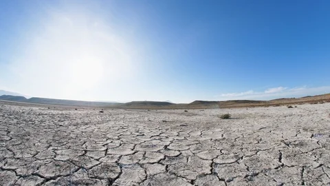 Camera fly over the dried valley to the sun Stock Footage 98179608