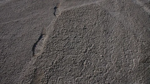 Camera fly over the dried valley to the sun Stock Footage 98414442