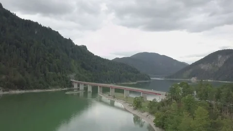 Camera fly towards the long bridge across the lake - Aerial side Stock Footage 83736813