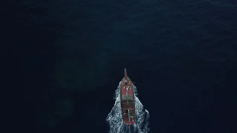 Camera flying above speeding boat at the blue ocean. Boat dissecting blue ocean Stock Footage 95425267