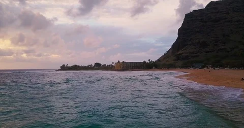 Camera flying along sandy beach at sunset Stock Footage 79621013