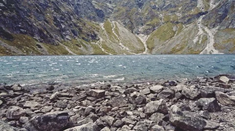 Camera flying to the lake shore in high mountings. Stabilized Slow-Mo, POV. Stock Footage 55874750