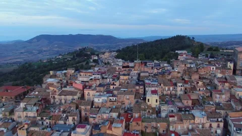 Camera flying low over Caltagirone by sunrise Sicily Stock Footage 166644955