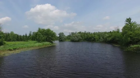 Camera flying low over the river then reveals Canadian Landscape. Stock Footage 52081266