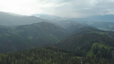Camera is flying over amazing pine forest on mountain, through clouds, moving Stock Footage 109062716