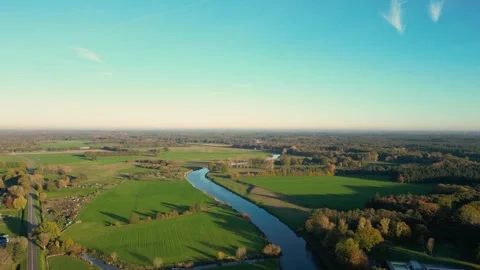 Camera flying over beautiful green countryside with river Stock Footage 293158002