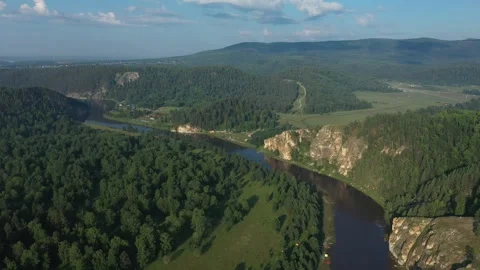 Camera flying over beautiful green valley with river 動画素材 296597920