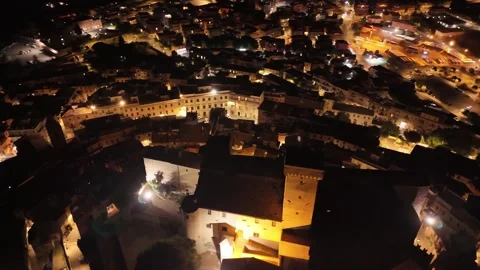 Camera flying over illuminated medieval italian town at night Video stock 282606228