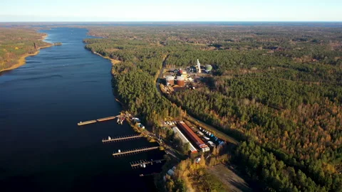 Camera flying over river and showing industrial building near fores, aerial Stock Footage 292966065
