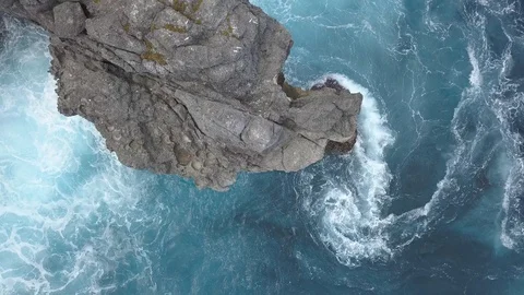 Camera flying over rocky cliff with turbulent water Stock Footage 94152059