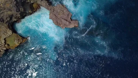 Camera flying over rocky cliff with turbulent water Video stock 94156032