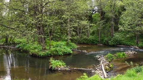 Camera flying over small river dam, and upstream Stock Footage 132384727