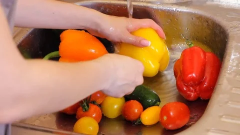 Camera is flying slowly and low over a bunch of different vegetables with water Stock Footage