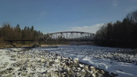 Camera flying under small steel bridge. Mountain river. Afternoon.  Video stock 147632262