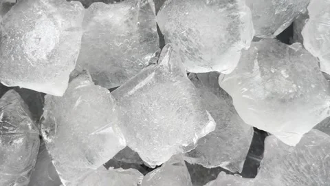 Camera flyover above large clear ice cubes macro texture Stock Footage 336506911