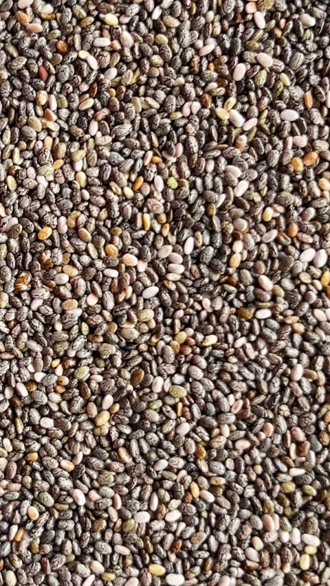 Camera flyover above raw chia seeds macro texture Stock Footage 336506965
